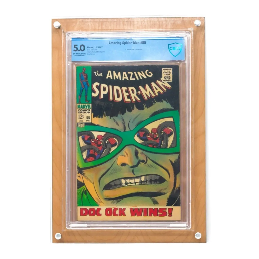 Photograph of the Crafti Comics UV-FLEX Display Case with light wood backing. Frame for displaying graded comic books. 99% UV-protected, museum-quality acrylic standard. Hangs portrait or landscape with twin engraved mounting holes. Crafti's laser-cut layered designs provide depth without creating pressure. This Display Case features a Spider-Man comic book.