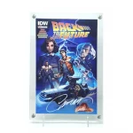 Photograph of the Crafti Comics X-Slab for protecting and displaying comic books (Golden-Bronze and Modern sizes) and art prints (up to 7″x10.5″). Made from acid-free Tru Vue acrylic with optional 99% UV-protection back and front. A three-layer, recessed acrylic design provides up to 1/4″ of depth for thicker comics. Free EZL display stand included, allowing for instant table-top displayability. Add a Crafti Curator (our version of a tamper-proof slab “label”) to pair physical collectibles with digital experiences like COAs, photos, videos & more. Crafti's laser-cut layered designs provide depth without creating pressure. This photo features a Back to the Future comic.
